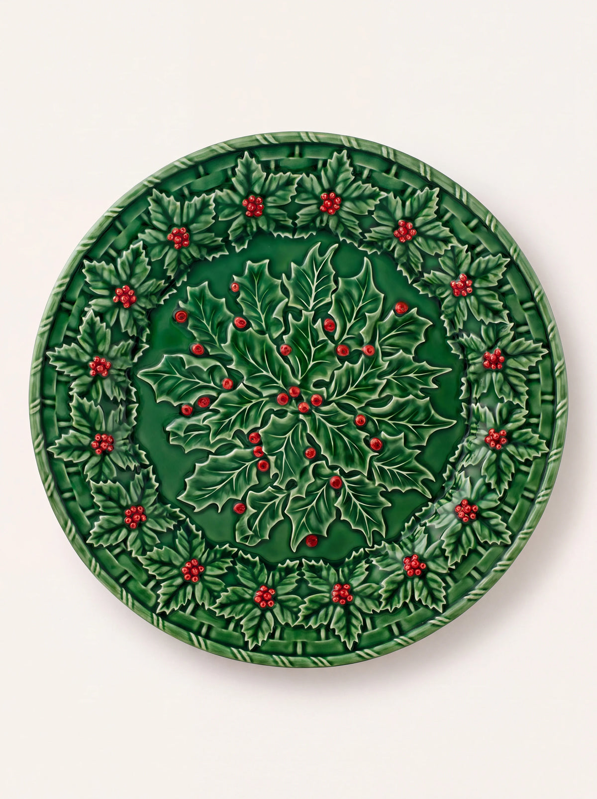 Green glazed earthenware charger plate with sculpted relief of holly leaves and red berries