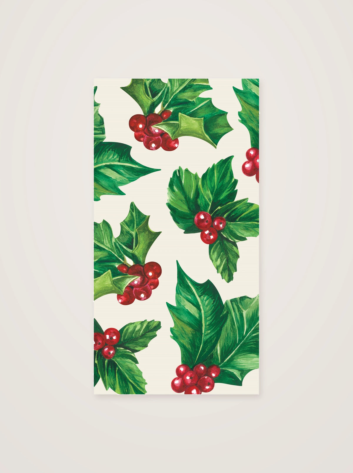 Holly paper guest napkin featuring an illustrated pattern of green leaves and red berry clusters