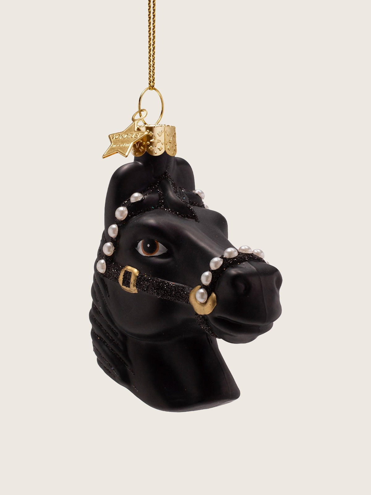 Horse head ornament in three-quarter view, showing the sculpted muzzle, painted eye and glitter halter