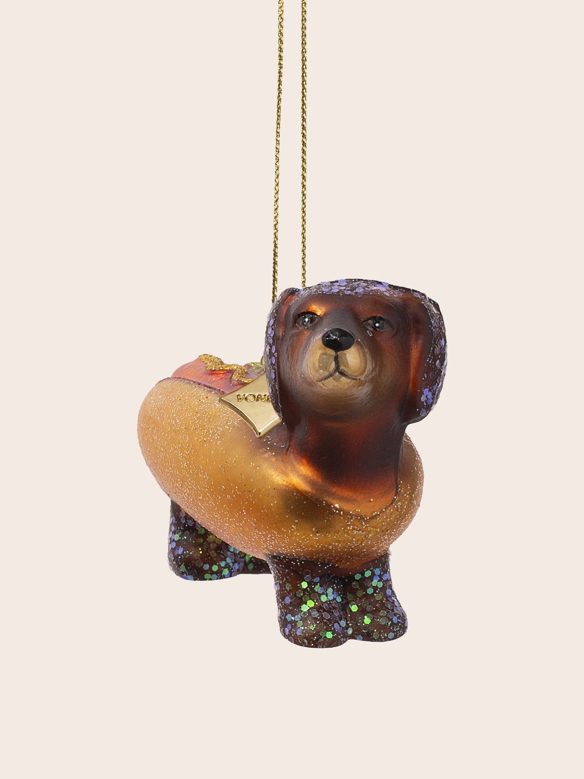 Three-quarter view showing the hand-painted face, glitter-covered ears, and sauce detailing along the back