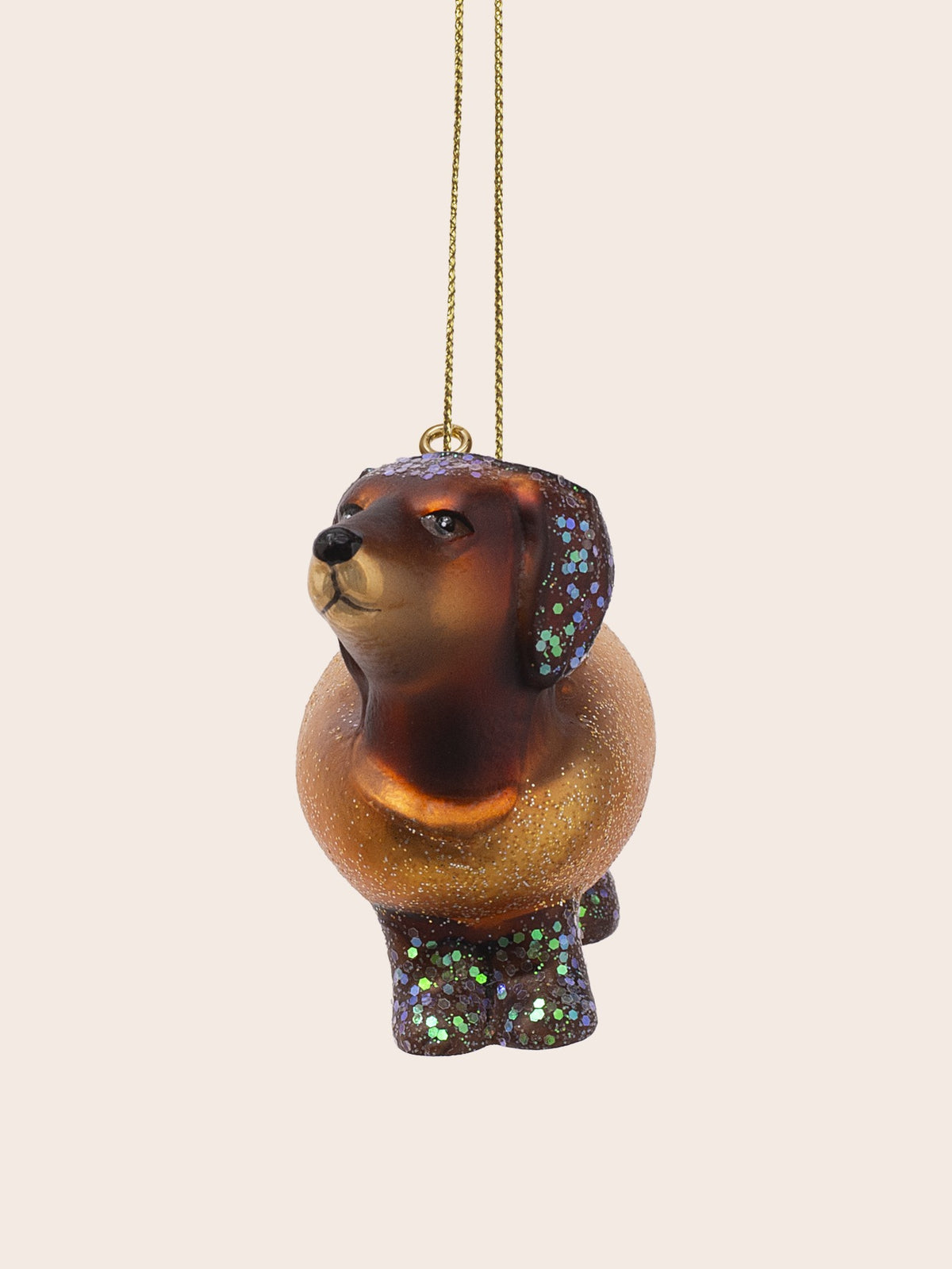 Front view showing the upturned head, rounded hotdog bun body, and glittered front paws