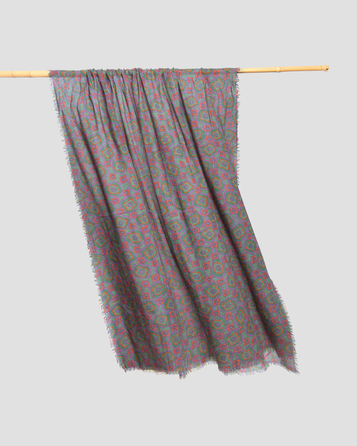 Khaki patterned wool scarf hanging gathered from a pole, showing the lightweight drape