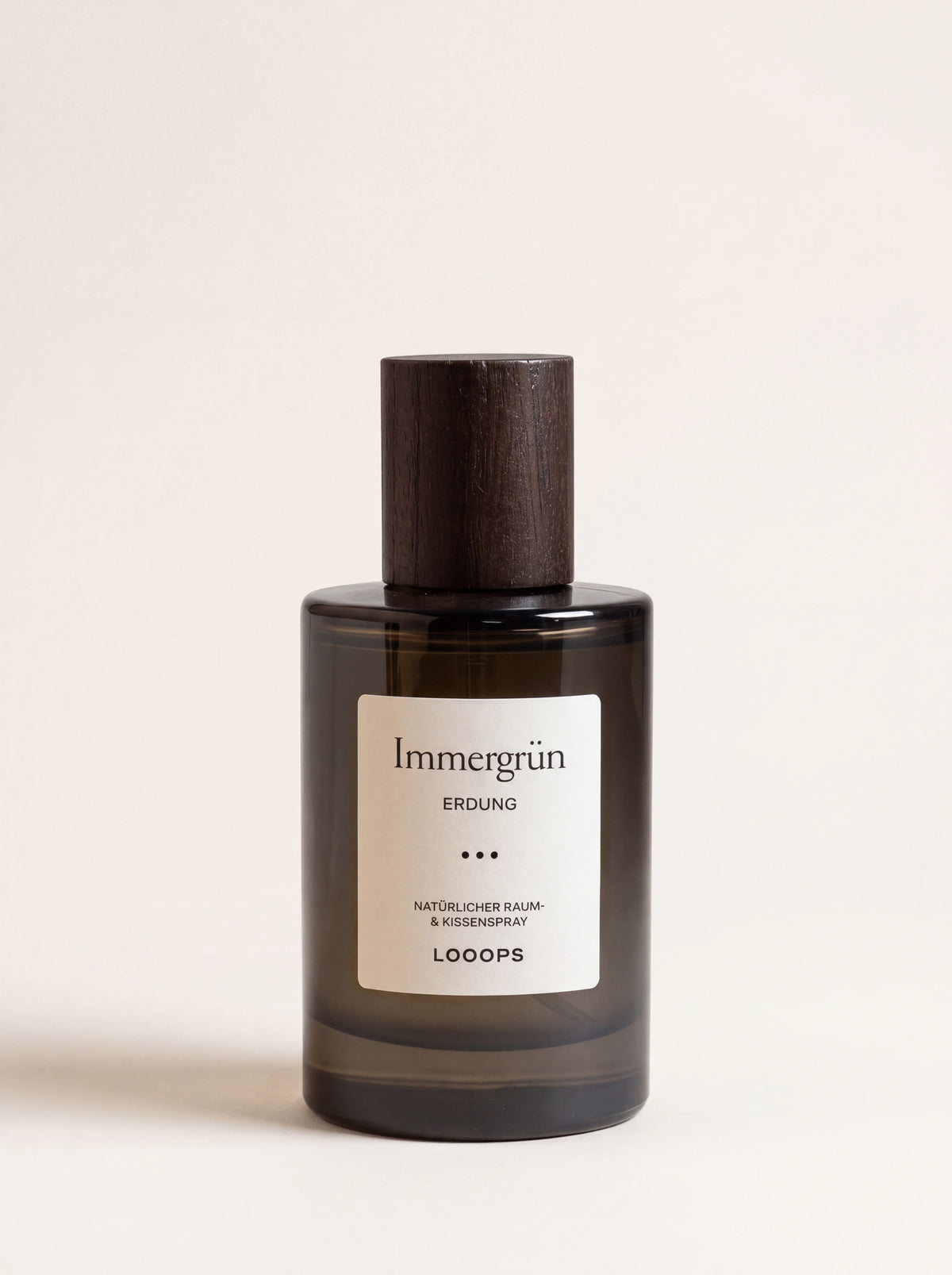 Room spray in a dark tinted glass bottle with a dark stained ash wood cap and Immergrün label