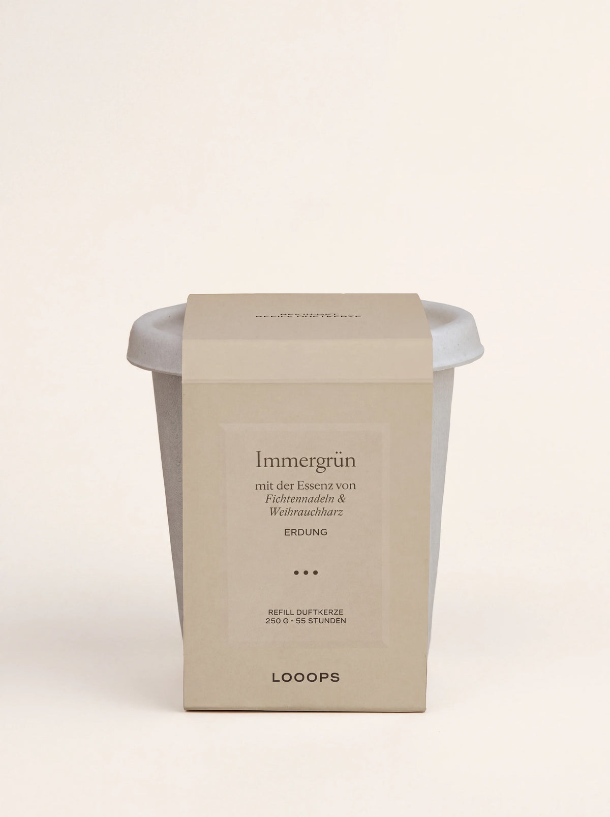 Scented candle refill in a light grey compostable cup with a beige paper sleeve labelled Immergrün