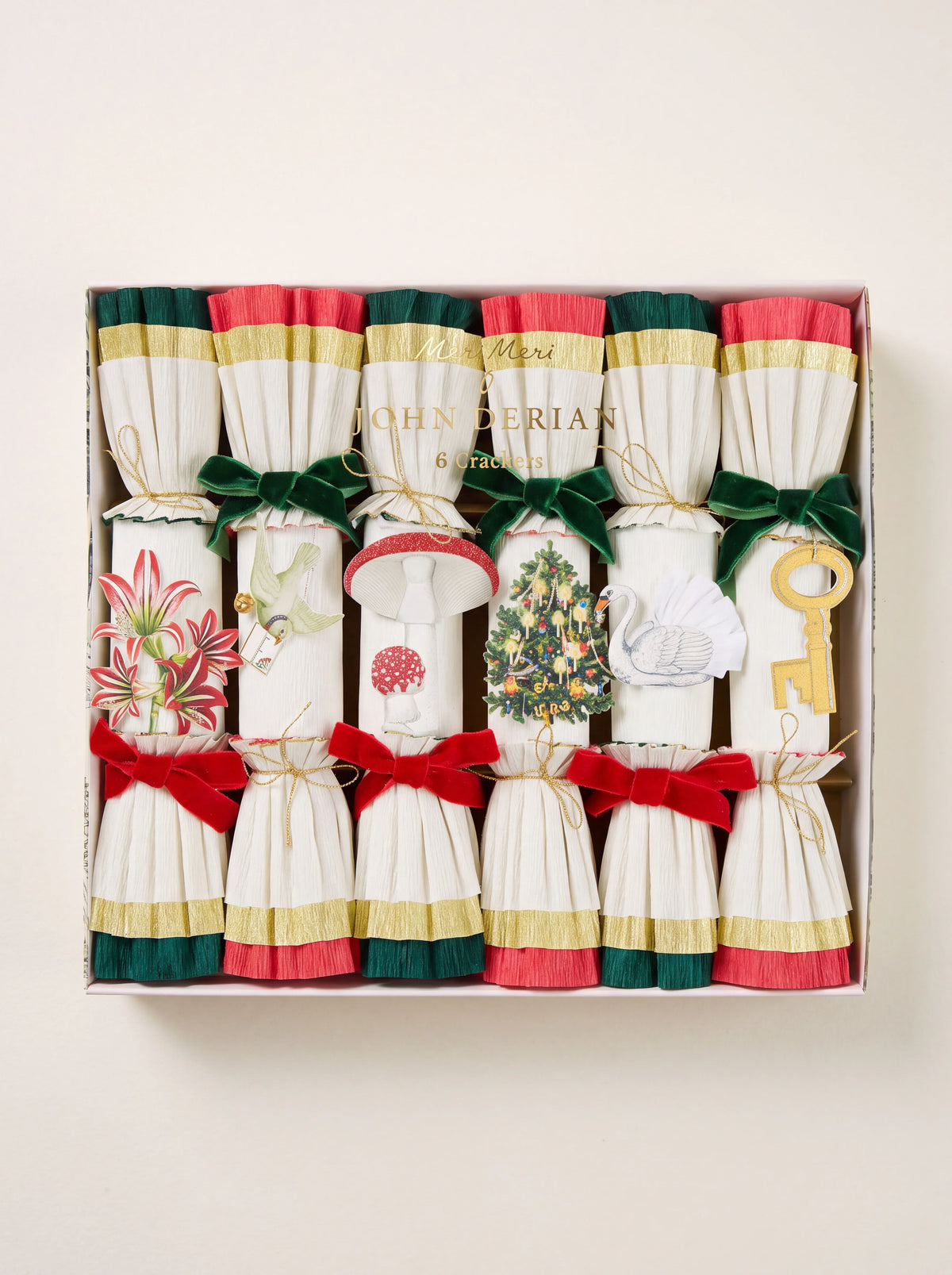 Set of six white crepe-paper Christmas crackers with illustrated motifs, ruffled trim, and velvet bows
