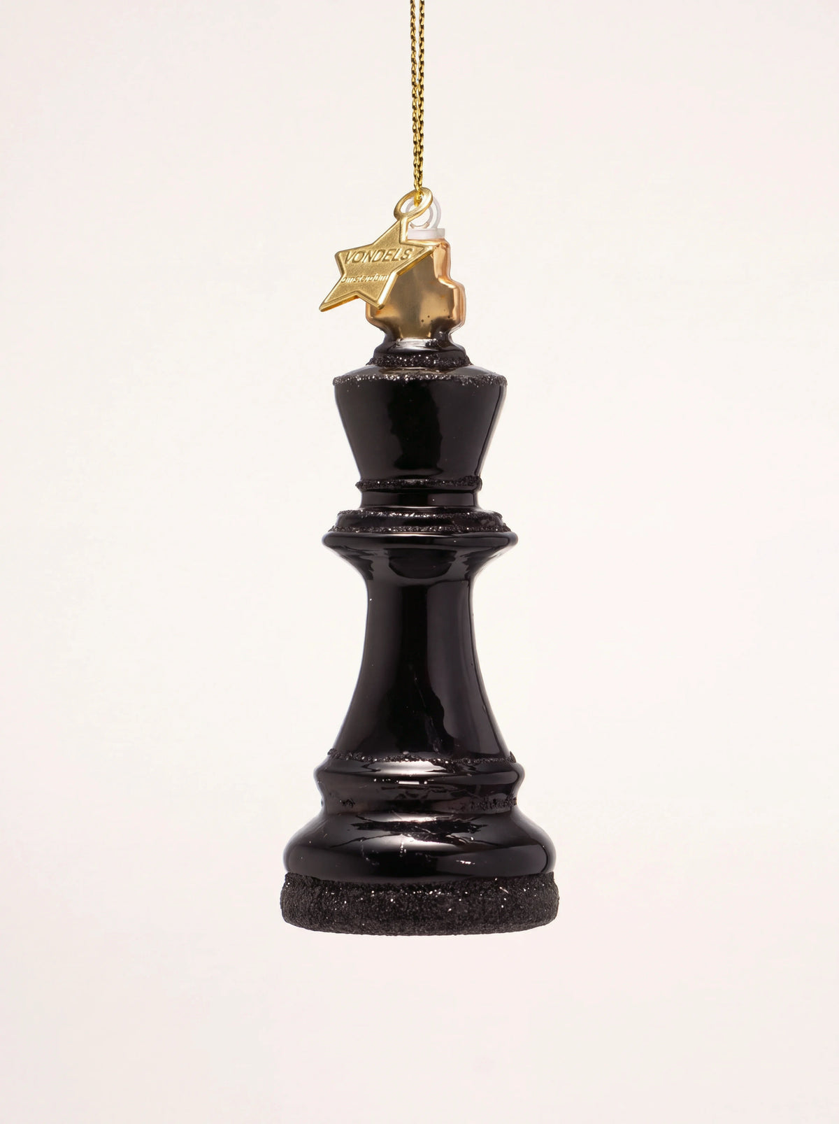Glossy black glass king chess piece ornament with black glitter detailing and a gold hanging string