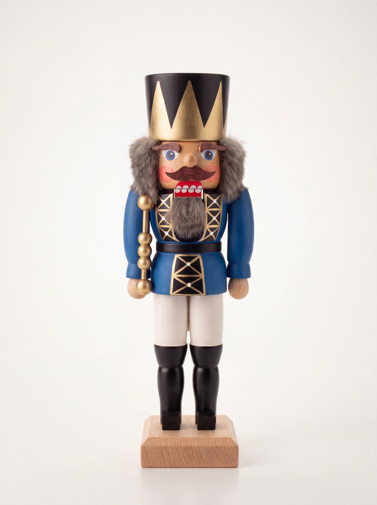 Blue wooden king nutcracker wearing a crown, holding a gold-tone sceptre, on a square wooden plinth