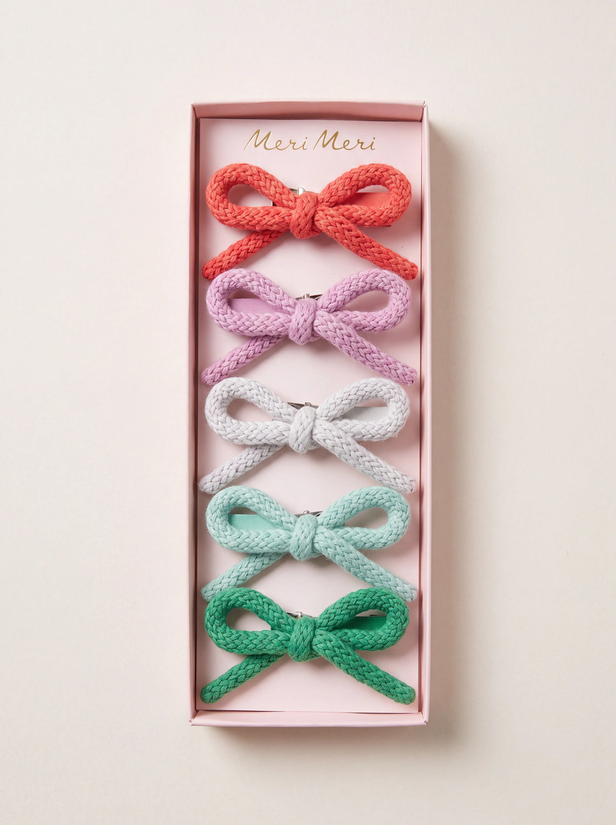 Set of five knitted cotton bow hair clips in red, pink, white, mint and green inside a Meri Meri box