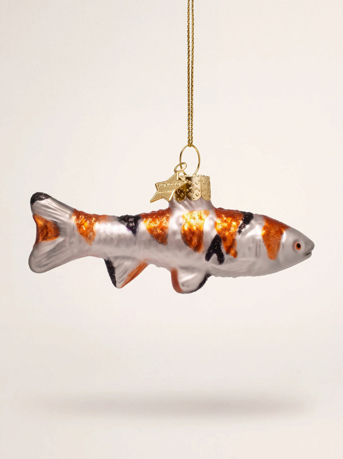 Glass koi carp Christmas ornament with pearlescent body, orange and black markings, and a gold hanging loop