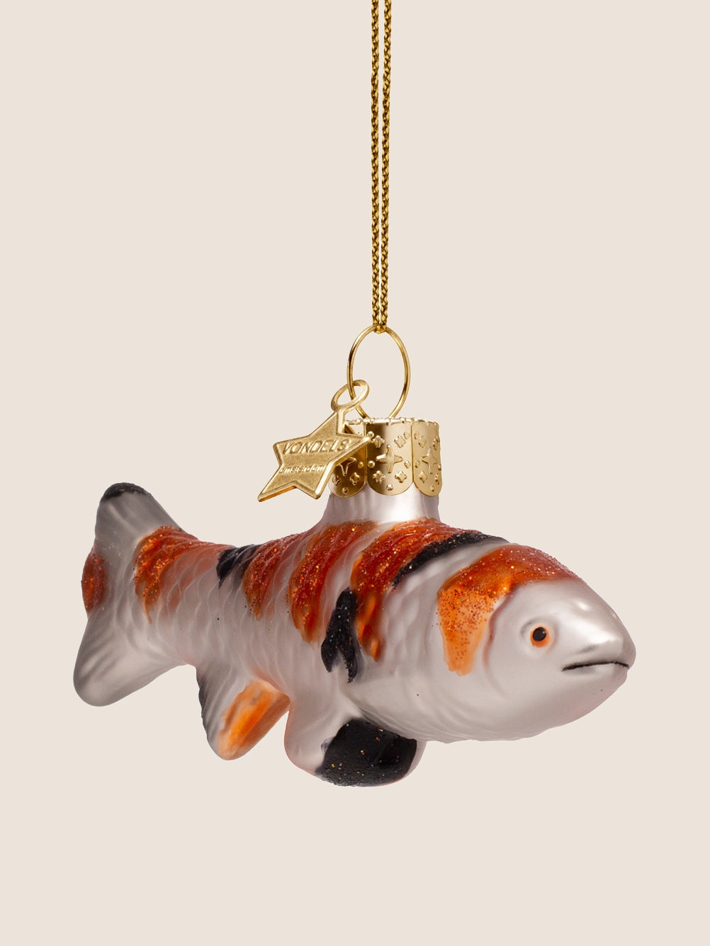 Three-quarter view of the koi carp ornament showing its sculpted head, painted eye, and glitter accents