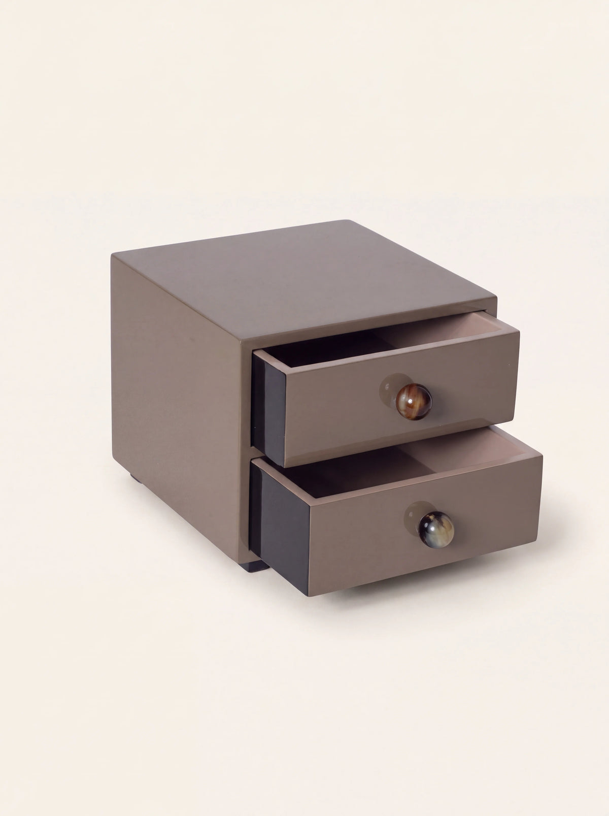 Earth-toned lacquered jewellery chest with two open drawers and round buffalo horn knobs