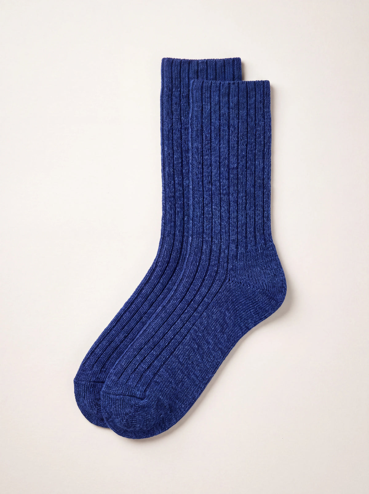 Dark blue ribbed lambswool socks with a smooth knit heel and toe, laid flat