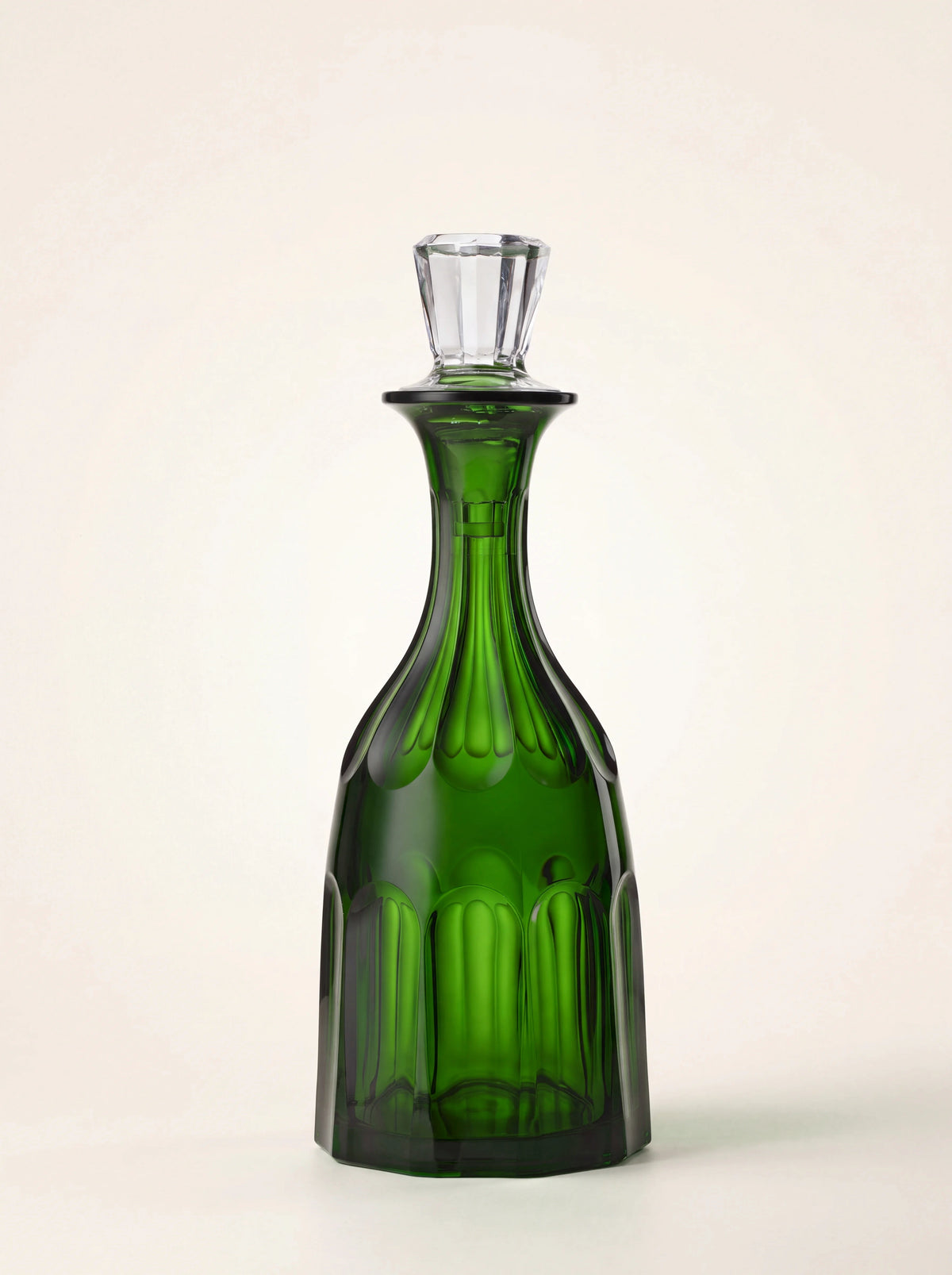Green acrylic bottle with a fluted neck, faceted body and clear stopper