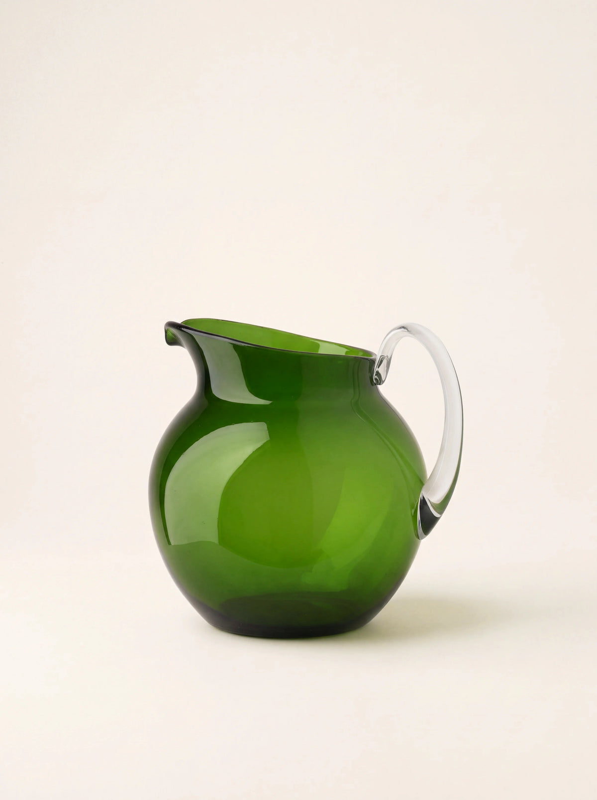 Dark green acrylic pitcher with a round body, pouring spout and clear curved handle