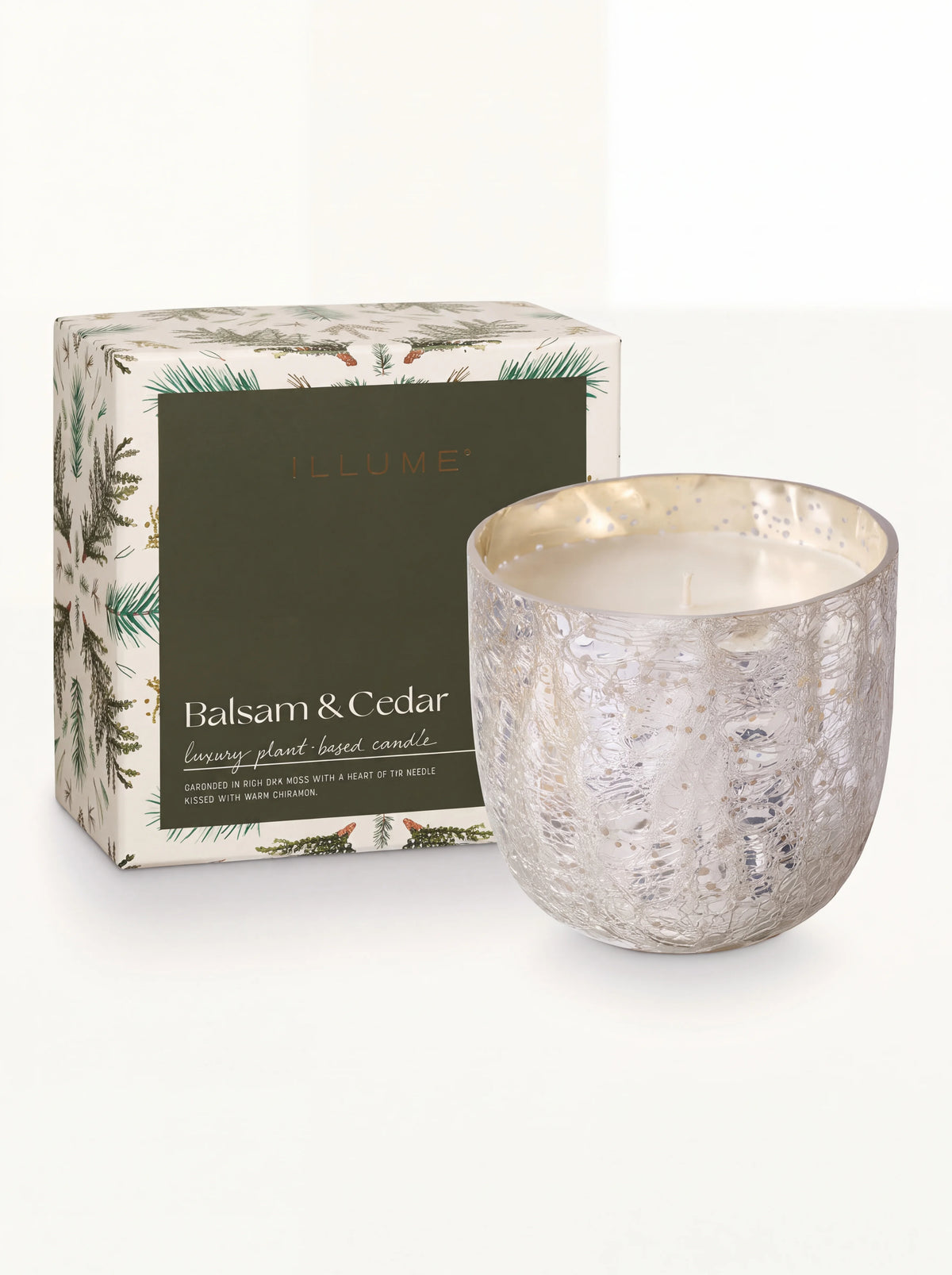 Scented candle in a silver crackle-glass vessel next to its illustrated Balsam & Cedar packaging box