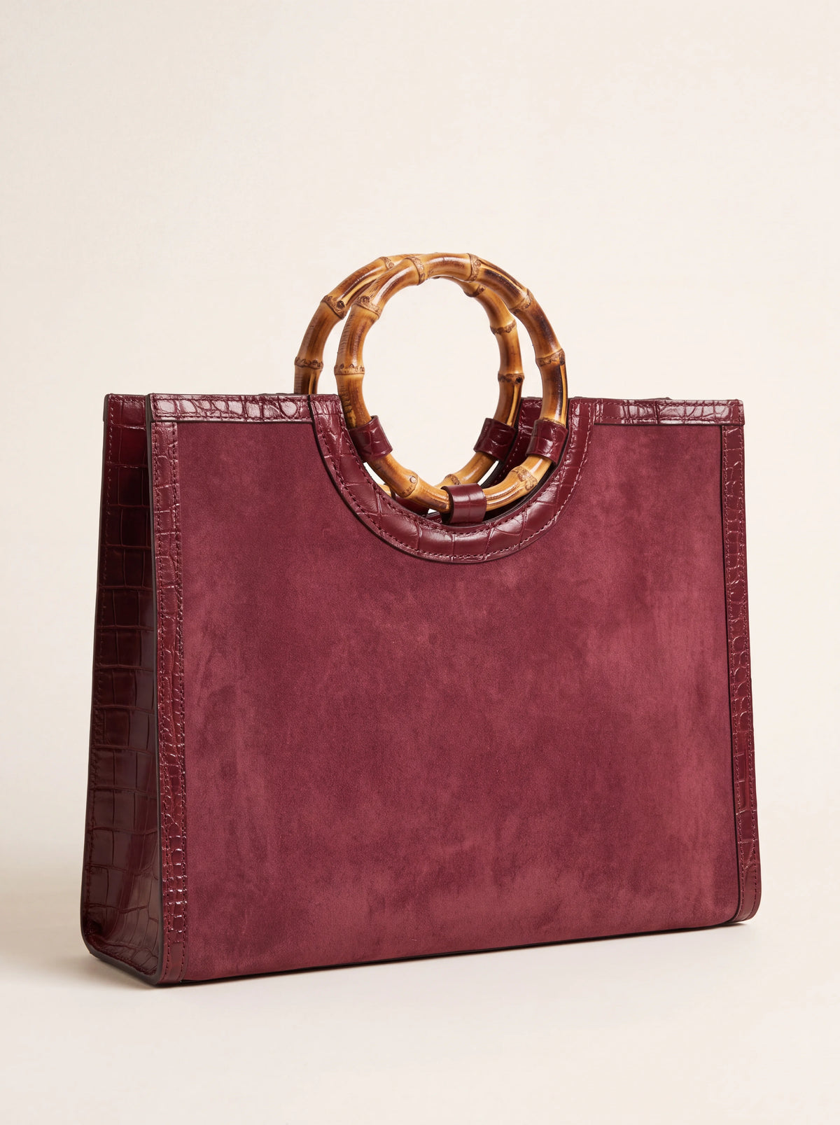 Plum suede structured handbag with crocodile-effect leather trim and round bamboo handles