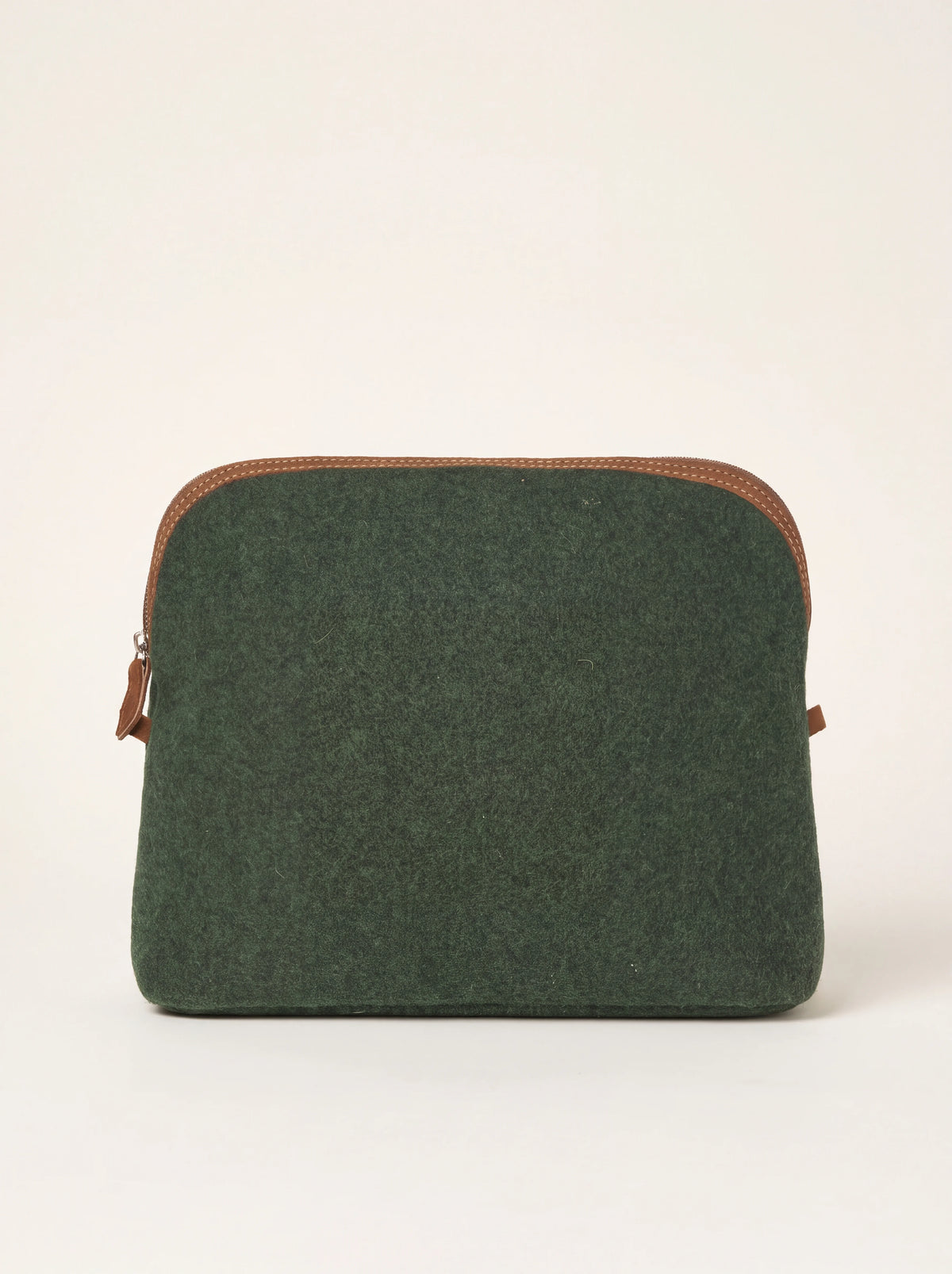 Green felt pouch with brown suede trim along the curved top zip closure