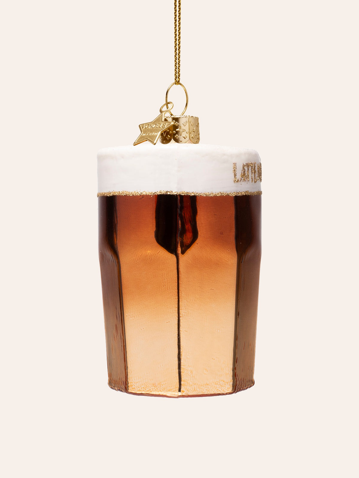 Side view of the latte macchiato ornament showing its faceted glass shape and glitter border