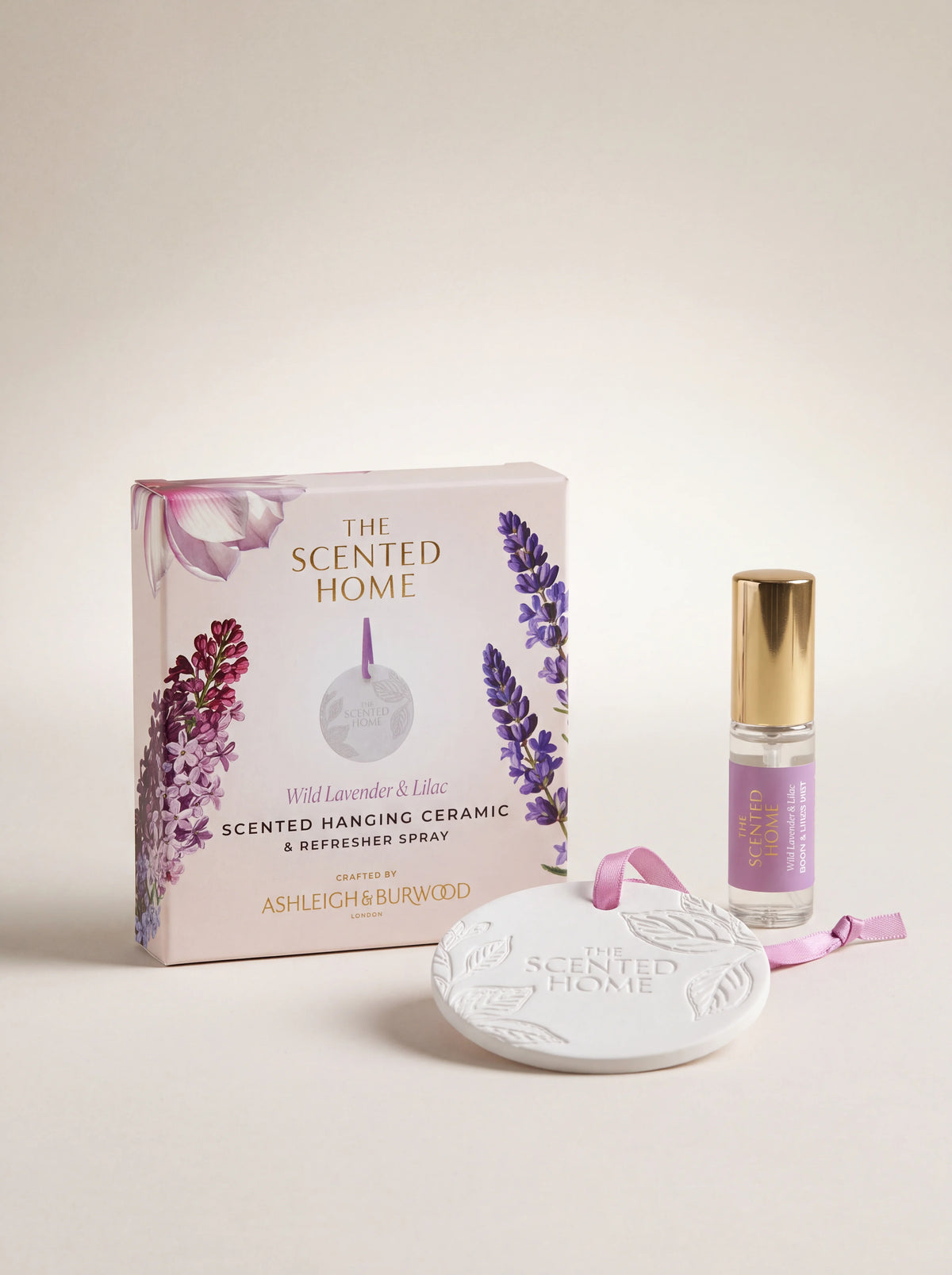 White embossed ceramic scent disc with lilac ribbon, glass refresher spray, and illustrated packaging box
