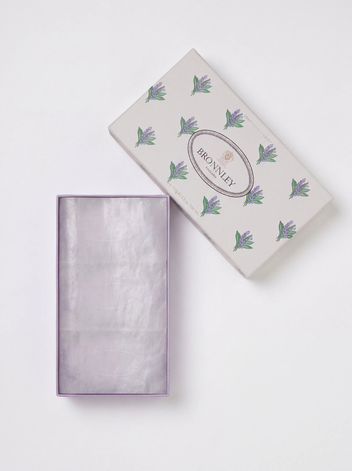 Lavender soap gift box open with lilac tissue paper lining beside lid patterned with lavender sprigs