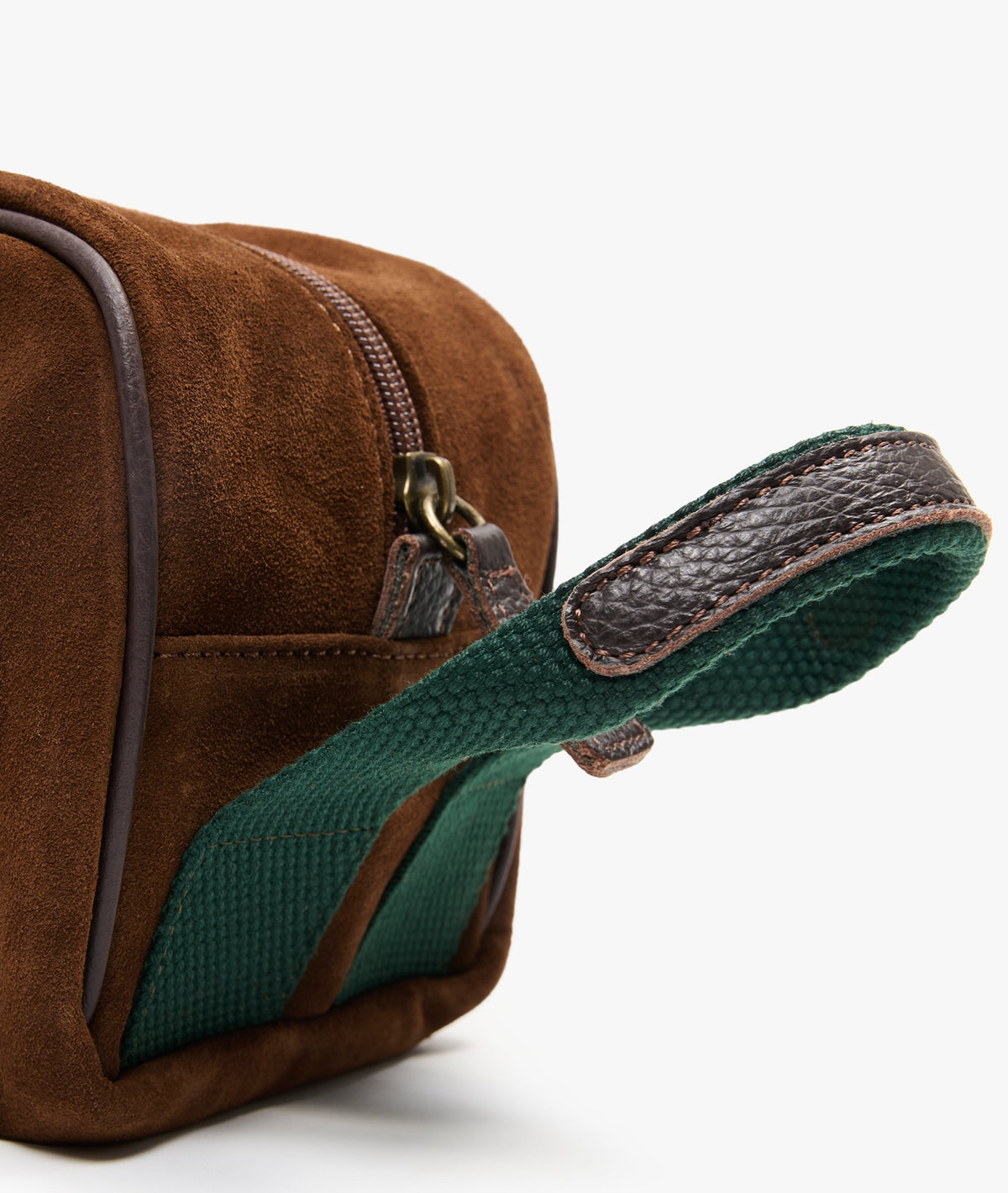 Close-up of the green webbing handle with textured leather grip and metal zip pull