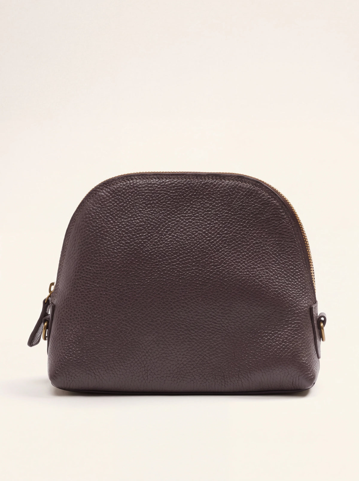 Domed cosmetic bag in dark brown pebbled leather with a curved top zip and flat base