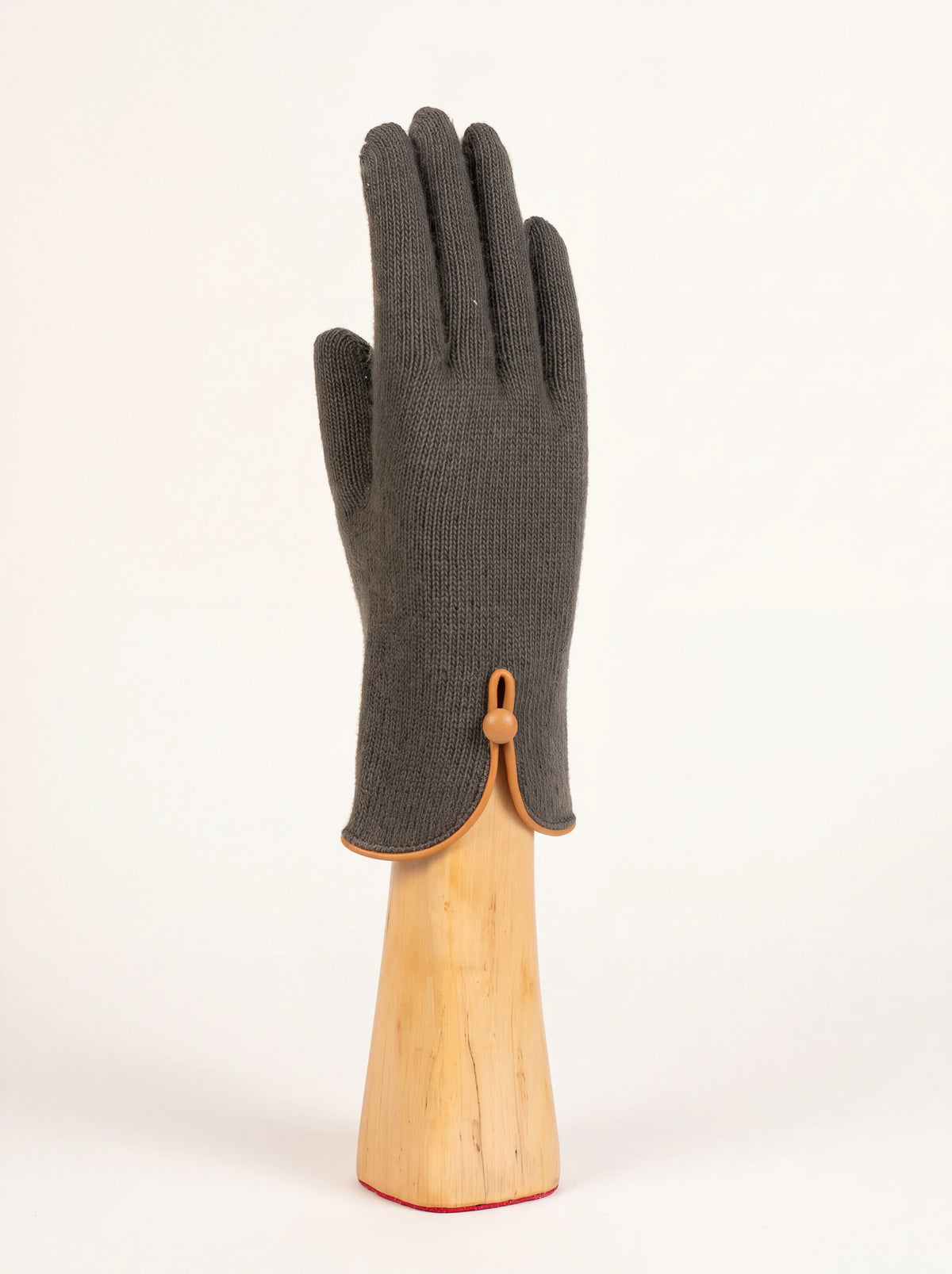 Dark green knitted wool and cashmere glove with curved cuff, tan leather trim and button fastening
