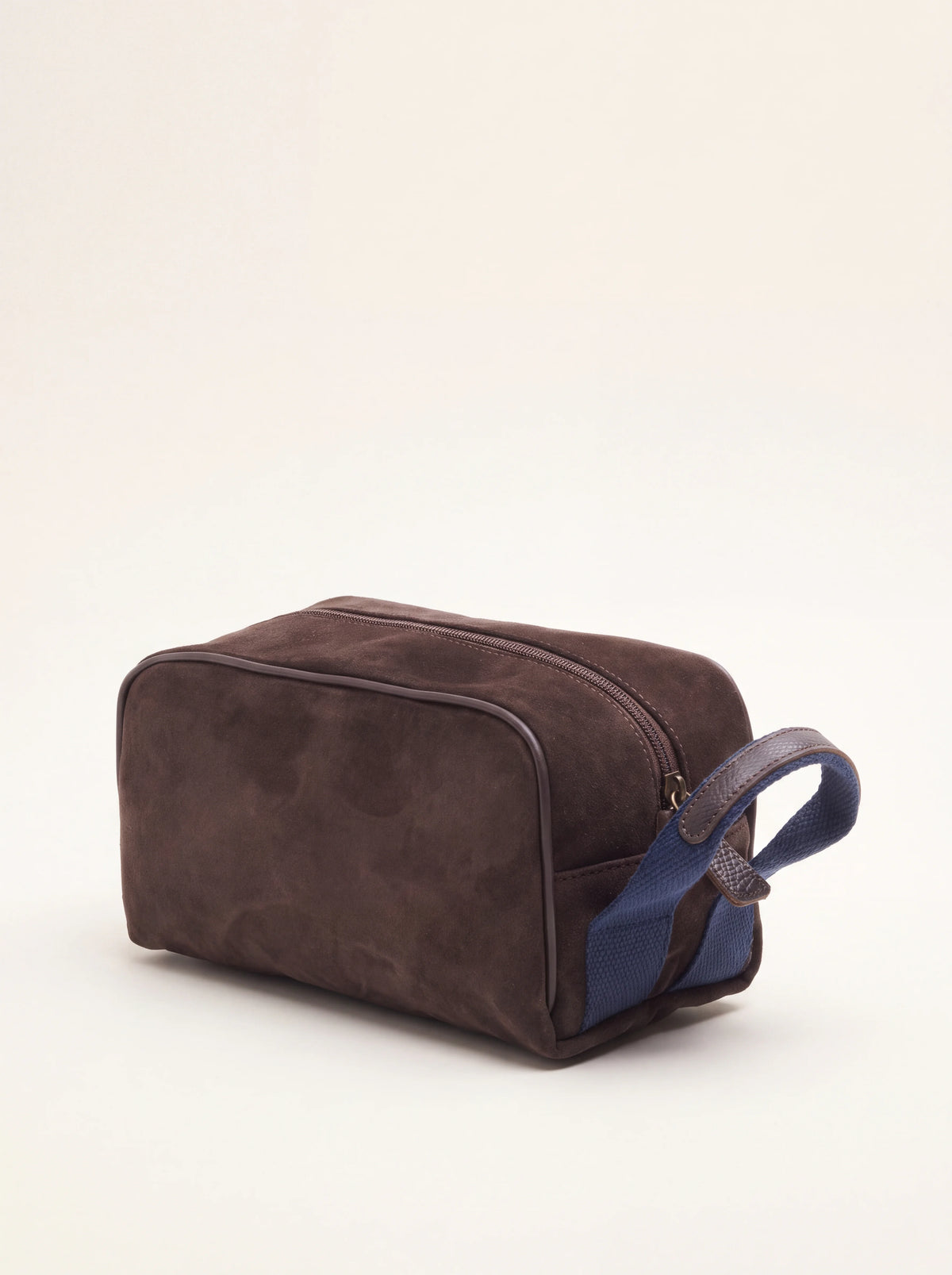Dark brown suede wash bag with smooth leather piping and a blue woven side handle