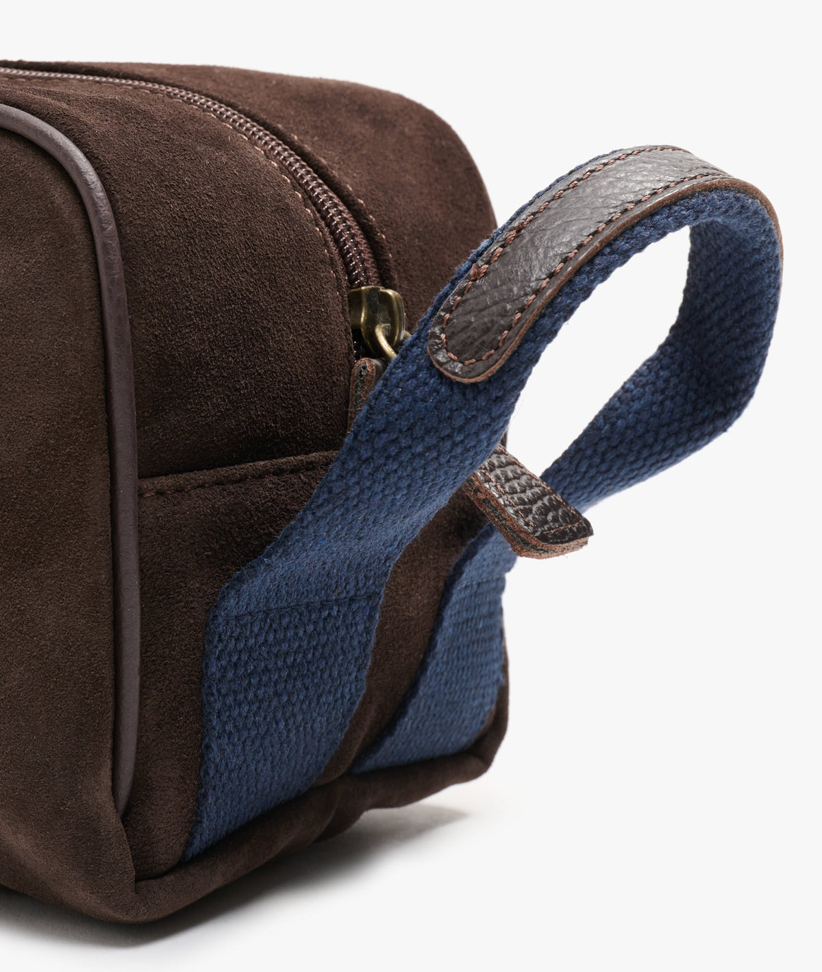 Close-up of the blue woven strap handle with stitched dark brown leather trim and metal zip pull