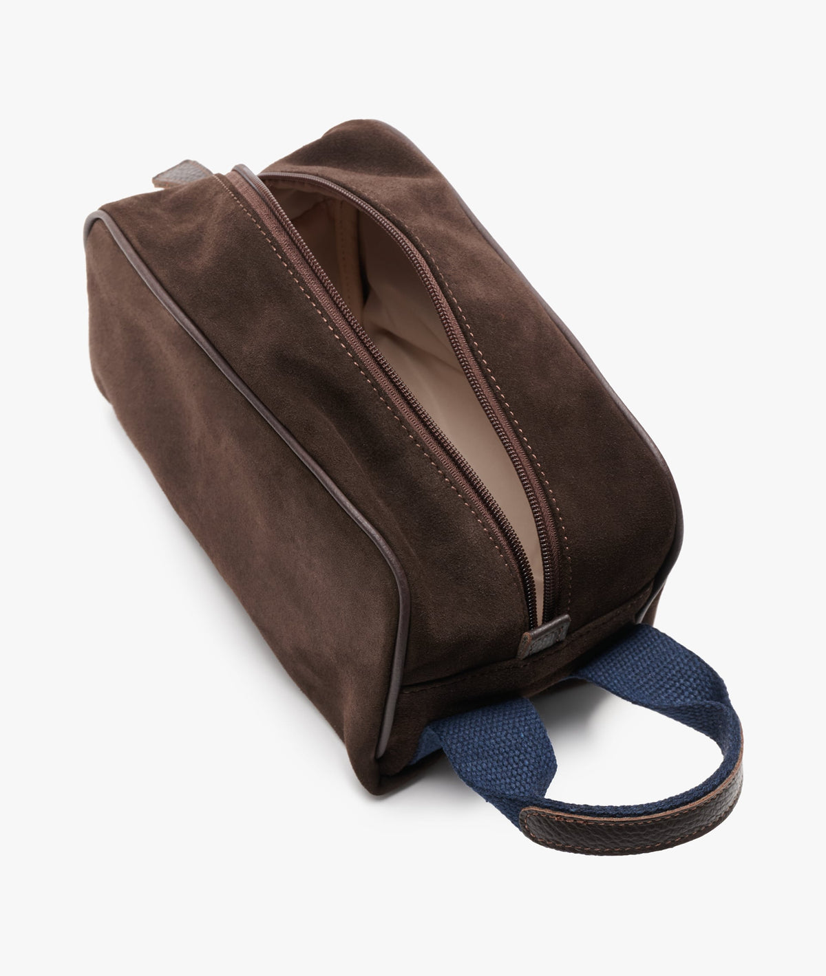 Top view of the suede wash bag partially unzipped, showing the light-coloured interior lining