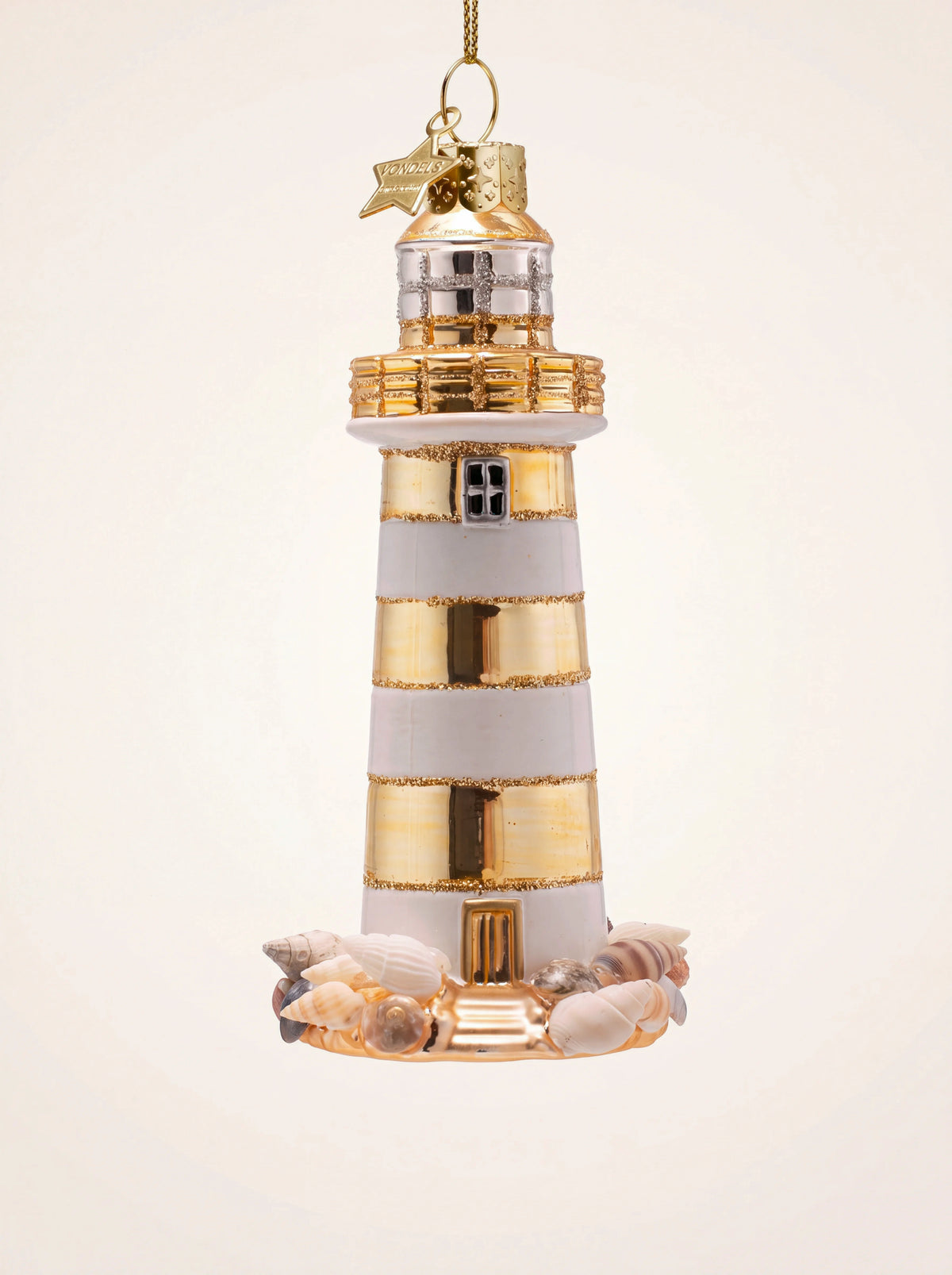 Glass lighthouse Christmas tree ornament with white and gold stripes, glitter trims, and seashell base