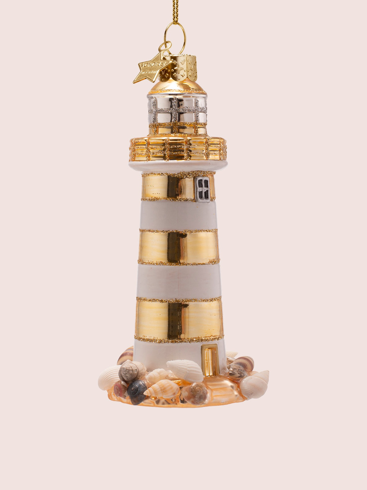 Three-quarter angle showing the gold entrance door and shell-encrusted base