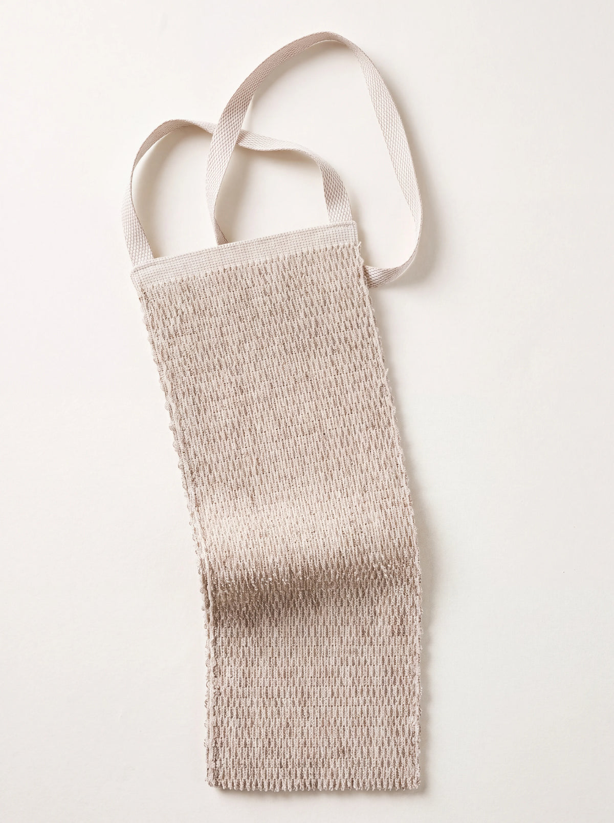 Textured linen terry back scrubber in natural beige with woven strap handles
