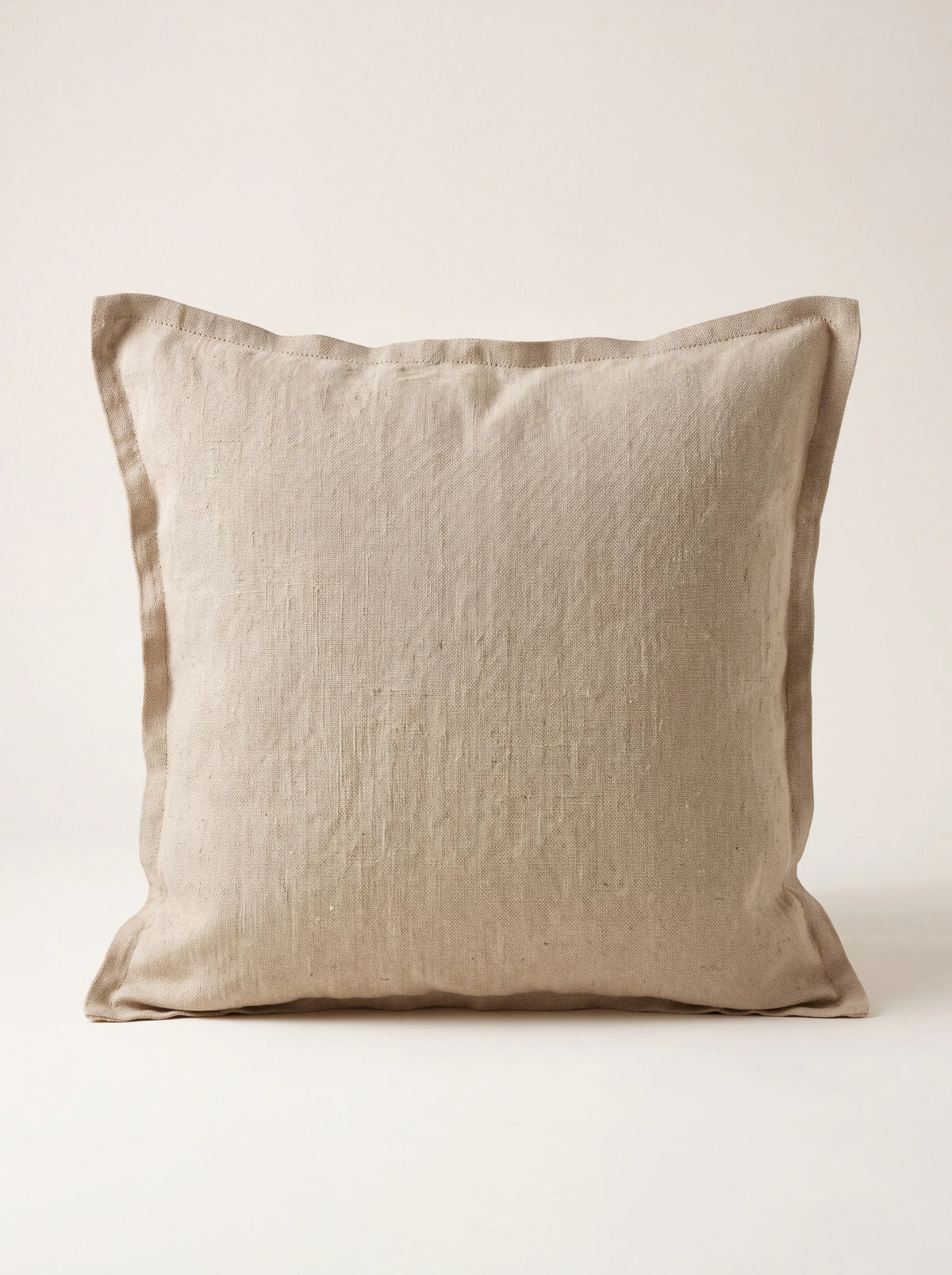 Square beige stonewashed linen cushion with a wide flanged border