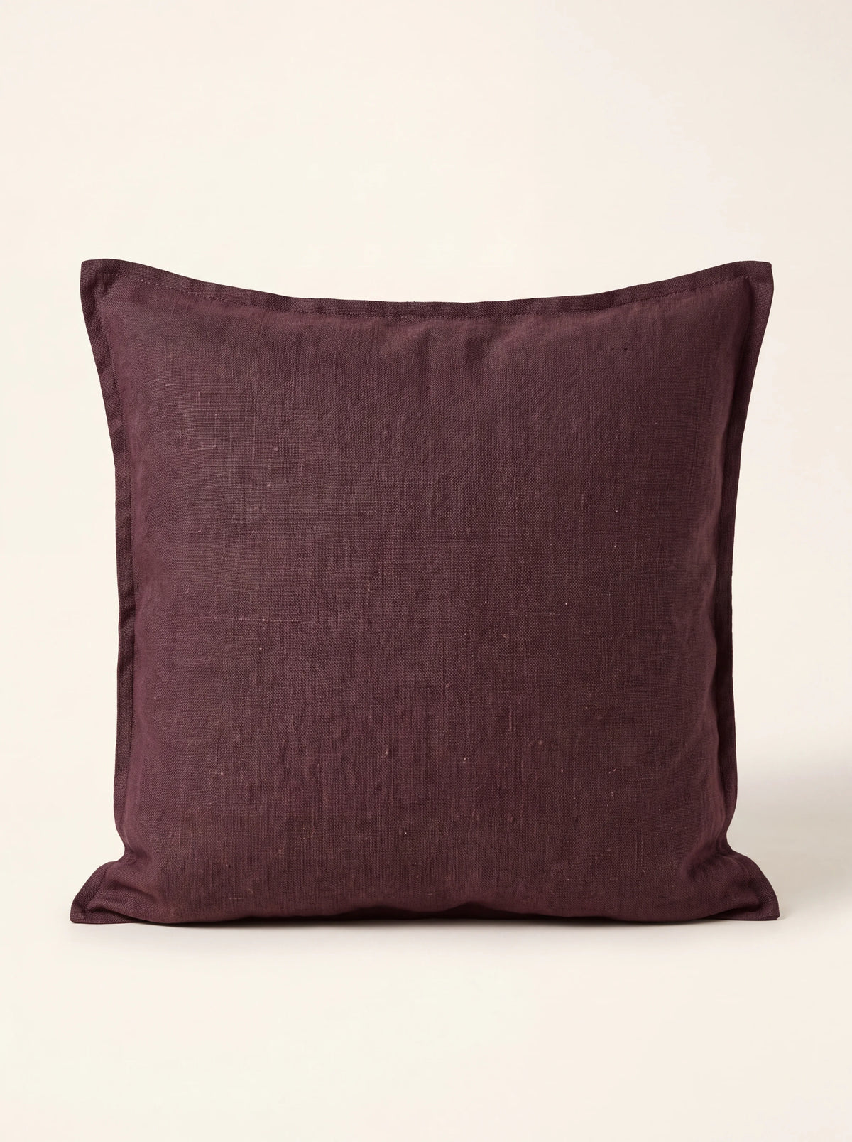 Square stonewashed linen cushion in deep fig purple with a double flange border