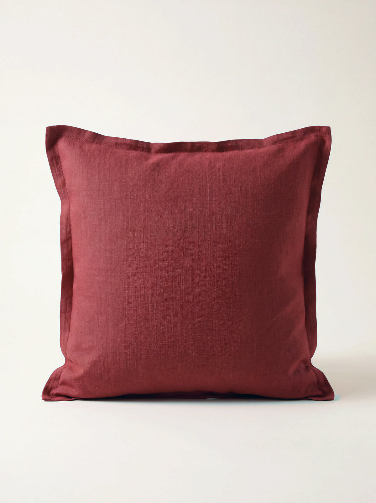 Square cushion in scarlet stonewashed linen with a double flange border
