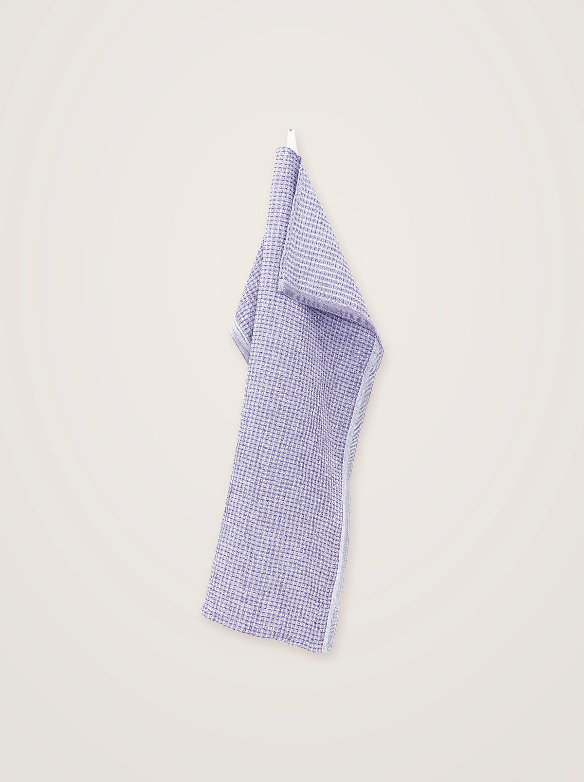 Lavender linen-blend towel hanging full-length, folded over at the top to show the reverse weave and finished hem