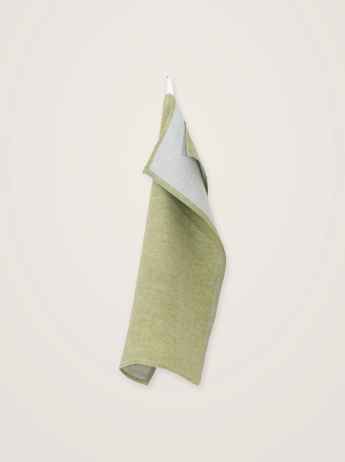 Olive-green washed linen towel hanging by its loop, draped to show the grey reverse