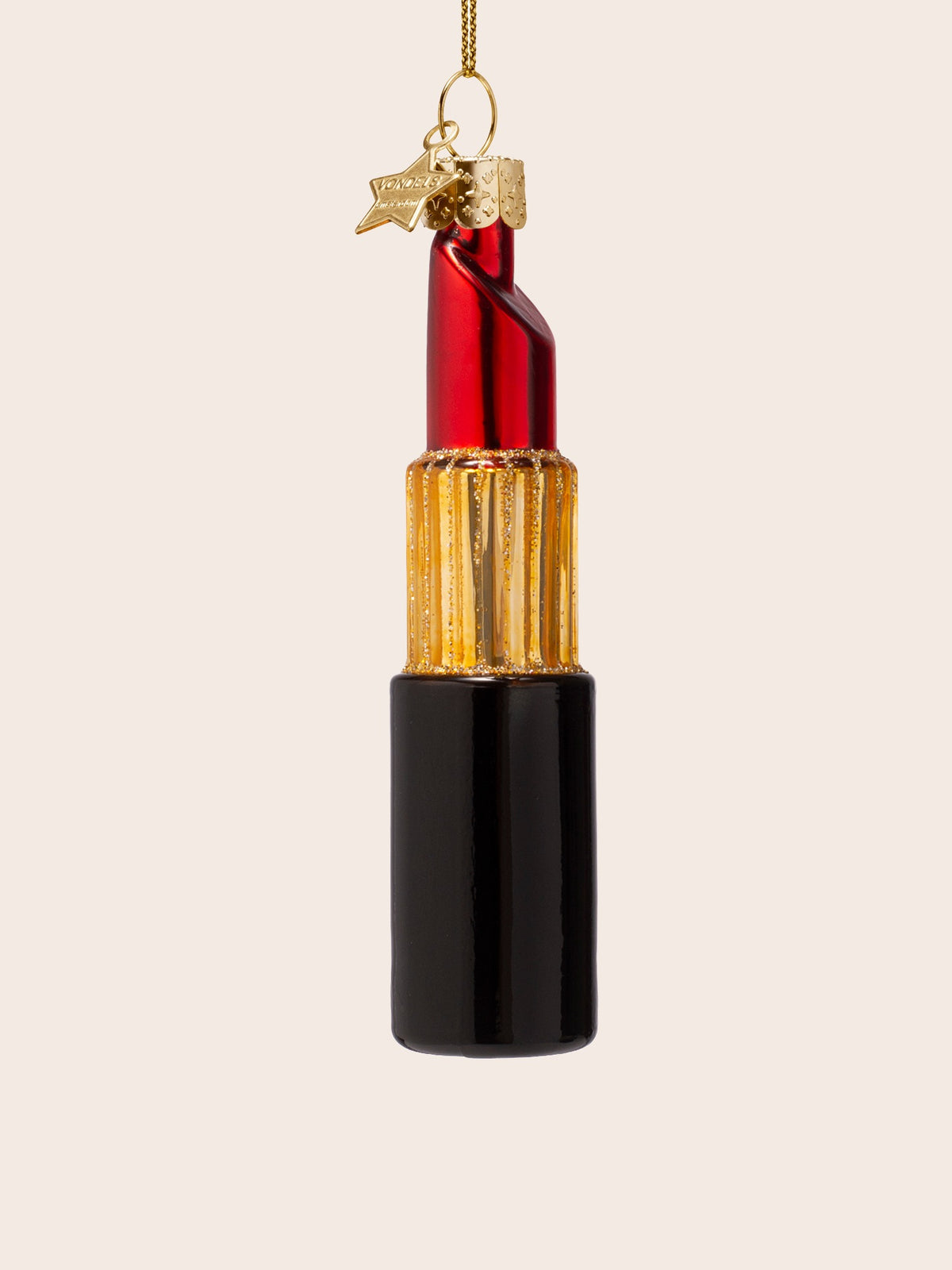 Reverse angle of the glass lipstick ornament showing the curved back of the tip