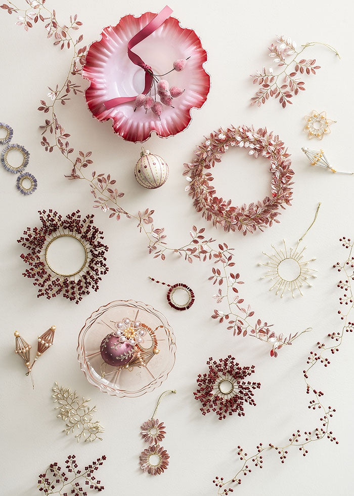 Beaded twig ornament styled in top right with coordinating pink and berry-toned decorations