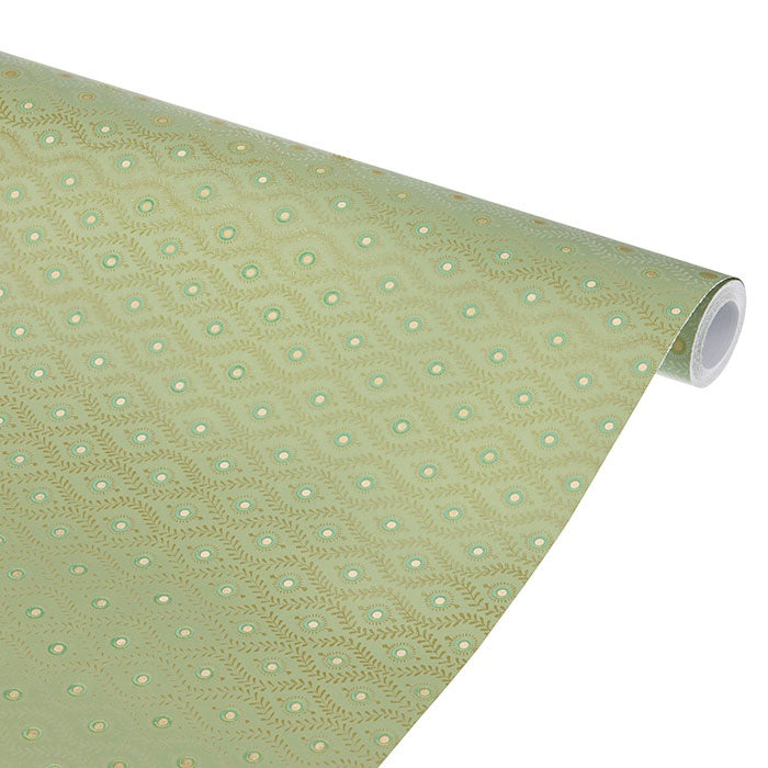 Sage green wrapping paper roll partially unrolled to show the tonal botanical motif