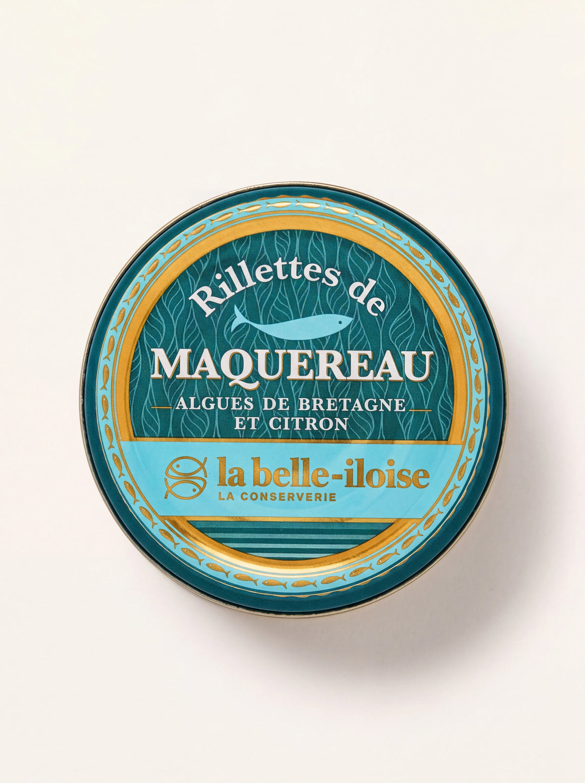 Round tin of seaweed and lemon mackerel rillettes with turquoise and gold fish design on the lid