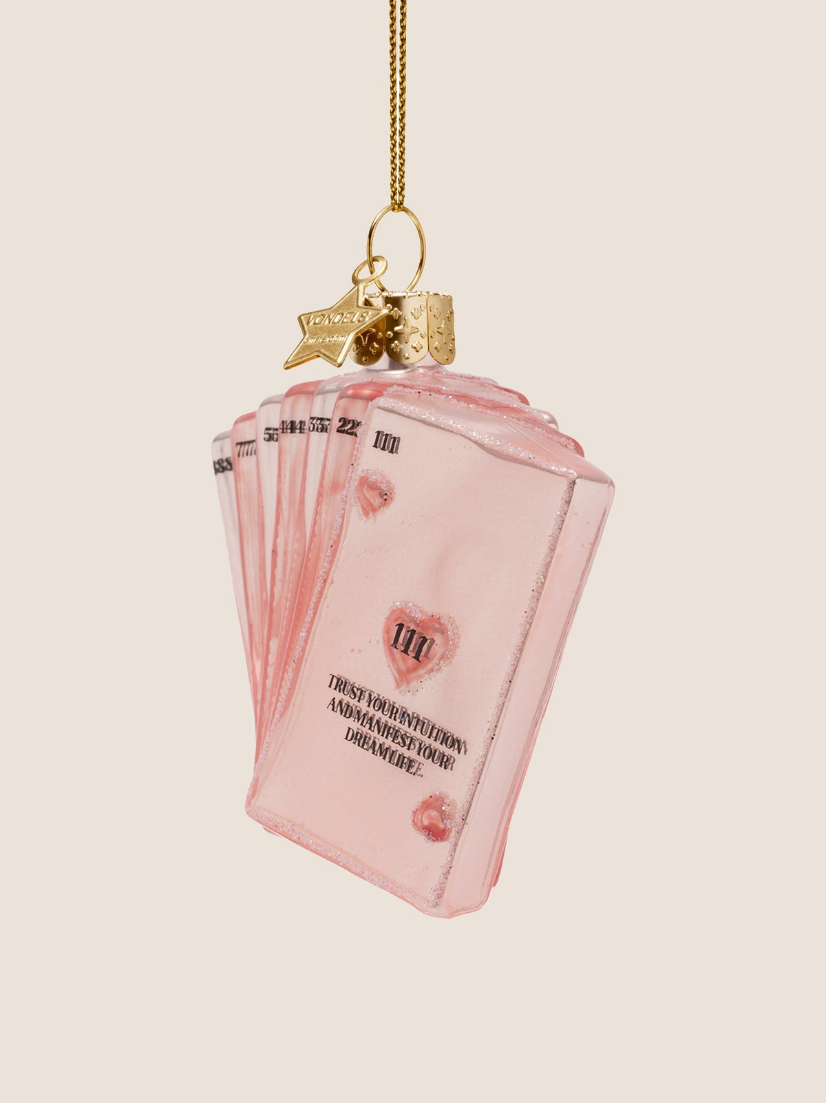 Three-quarter view of the pink glass cards ornament showing the fanned layers and glitter borders