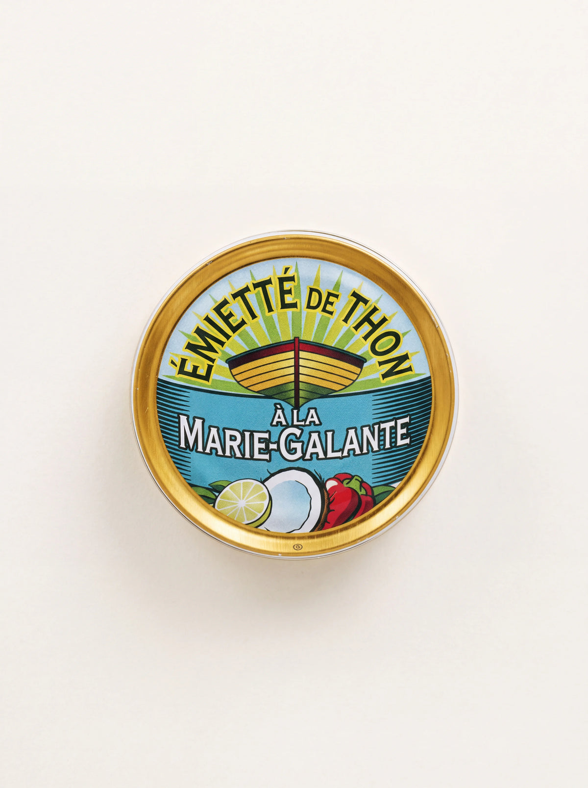 Round tin of flaked tuna labelled Émietté de Thon à la Marie-Galante with coconut and lime illustrations