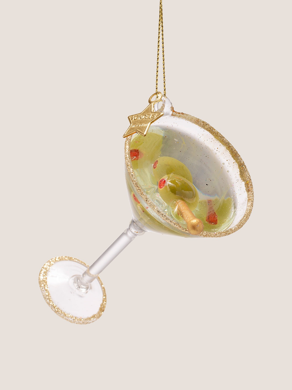Angled view showing the interior of the martini cocktail glass with red-stuffed olives on a skewer