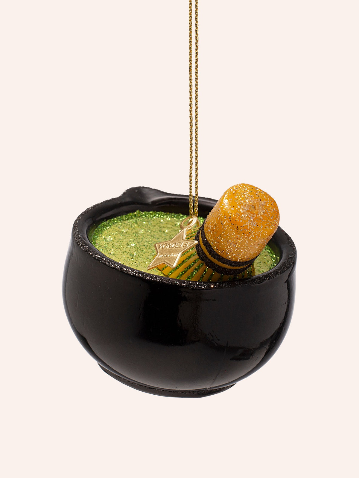 Overhead view showing the glittered green tea surface inside the bowl beside the whisk
