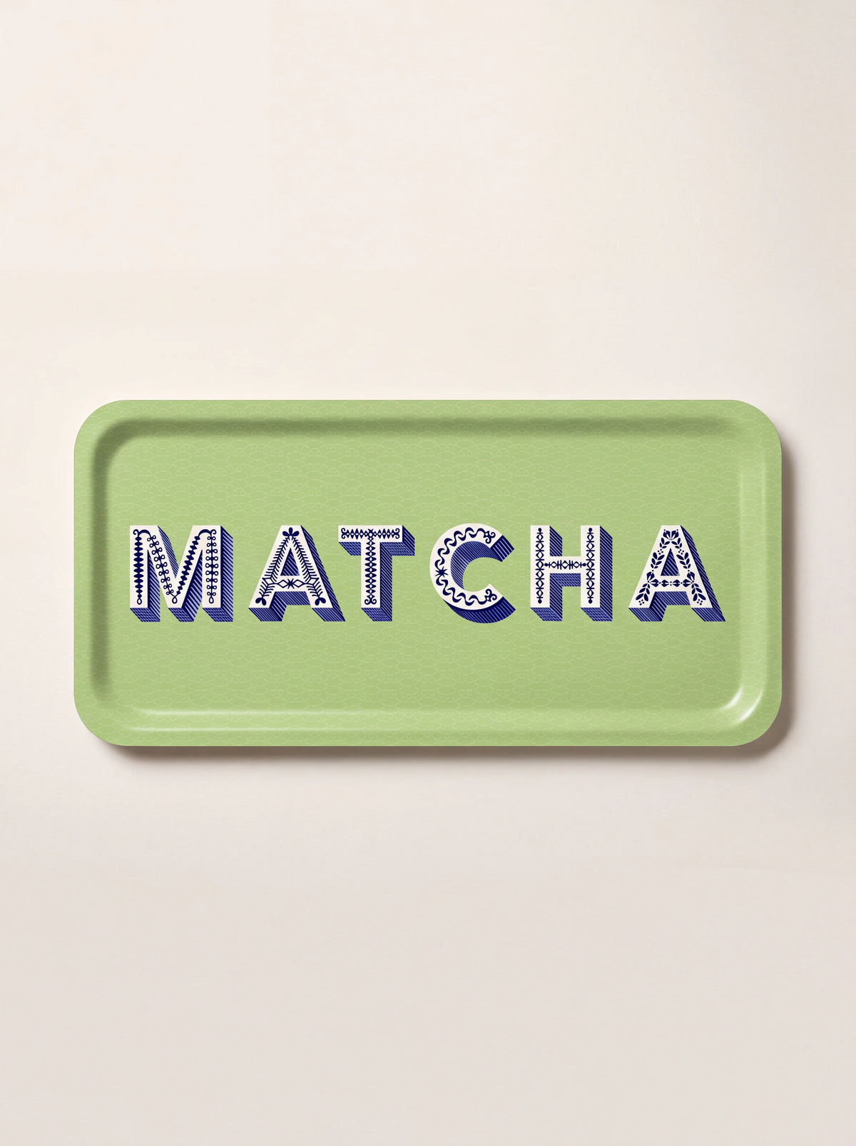 Rectangular light green tray with rounded corners and decorative blue MATCHA lettering across the centre