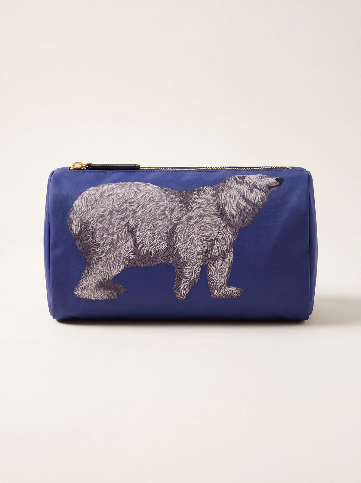 Blue fabric pouch with a white bear illustration and zip closure with leather pull tab