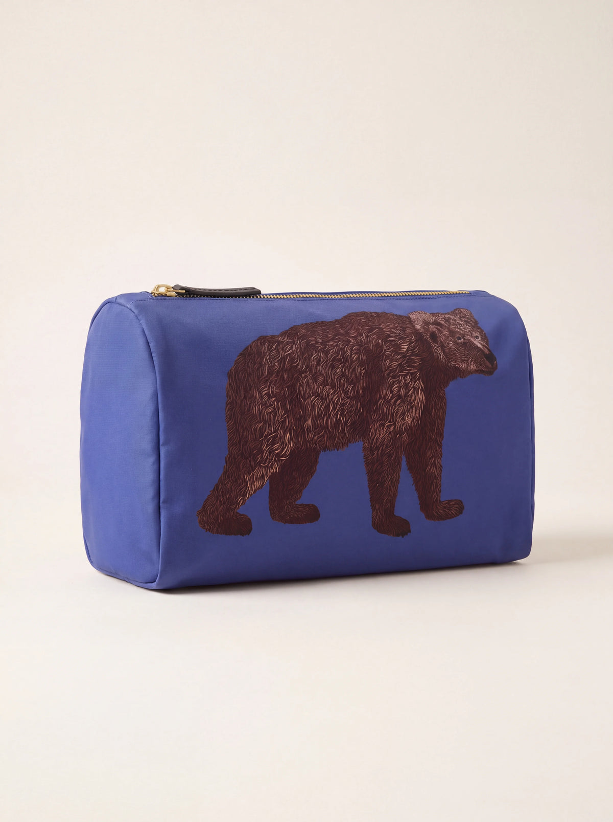 Reverse side of the blue fabric pouch featuring a brown bear illustration
