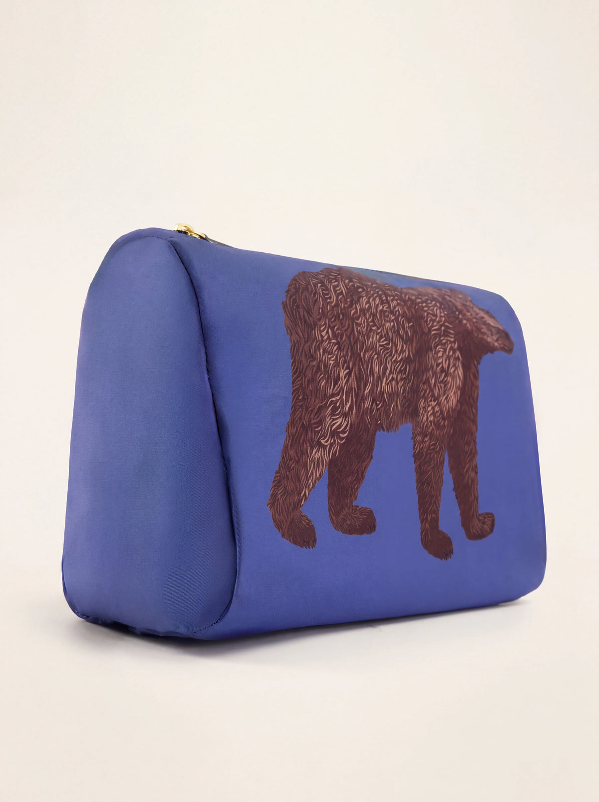 Three-quarter view of the blue fabric pouch showing its flat base and depth